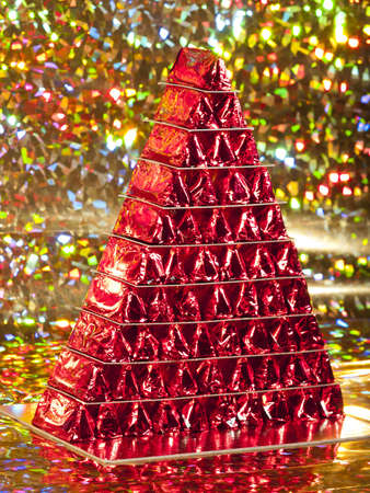 A red chocolate Christmas? tree on a multicolored backgroundの写真素材