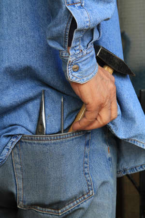 A worker with tools in his pocketの写真素材