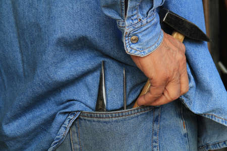 A worker with tools in his pocketの写真素材