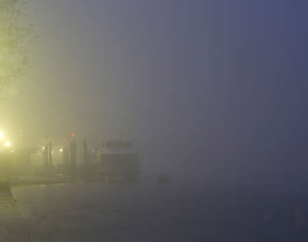A boat in the fog at the eveningの写真素材