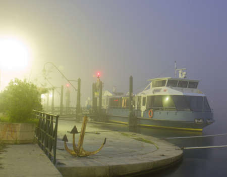 A boat in the fog at the eveningの写真素材
