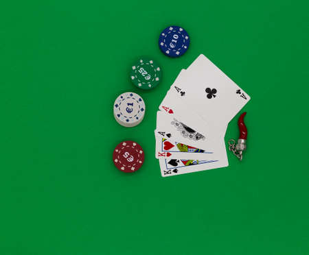 Poker cards, fishes and amulete on a green tableの写真素材