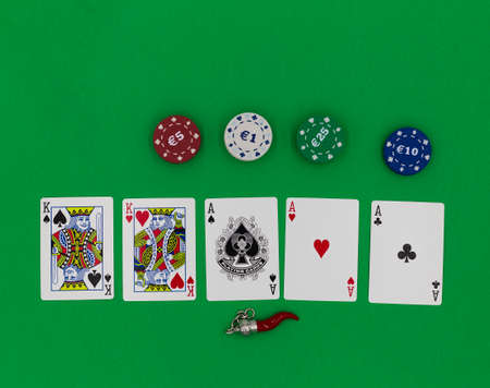 Poker cards and amulete on a green tableの写真素材