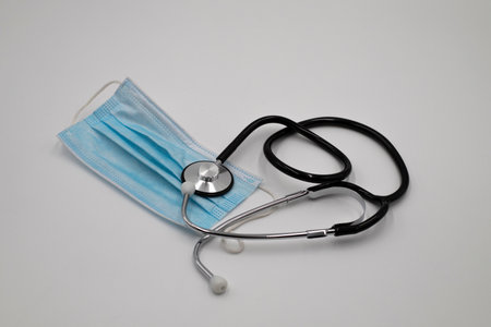 Surgical mask and stethoscope medical eqipment on white backgroundの写真素材