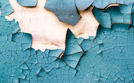wall texture with cracked peeling blue paintの写真素材