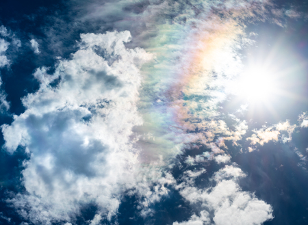 blue sky white clouds sun and rainbowの写真素材