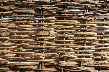 texture of wooden wicker fence close upの写真素材