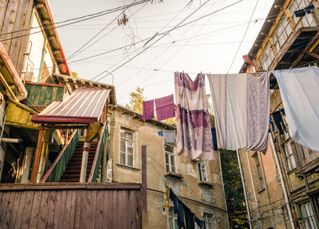 old houses with stairs and balconies with ropes and clothes in Tbilisi Georgia