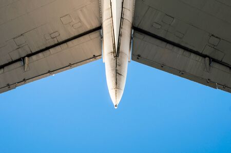 fragment of airplane wings on a background of blue sky isolated backgroundの写真素材