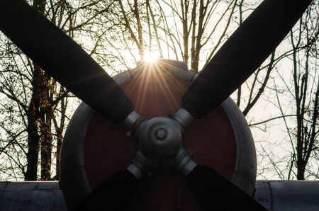propeller of a vintage airplane in the rays of the evening sunset close upの写真素材