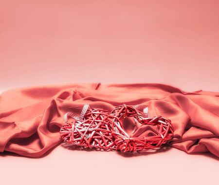 valentines day decor red heart on pink fabric love romantic background close up isolatedの写真素材