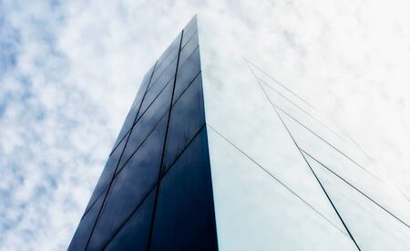 wall of a modern building against the sky and clouds abstract architectural backgroundの写真素材