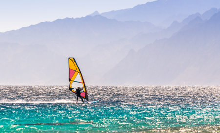 windsurfer rides on a background of high mountains in Egypt Dahabの写真素材