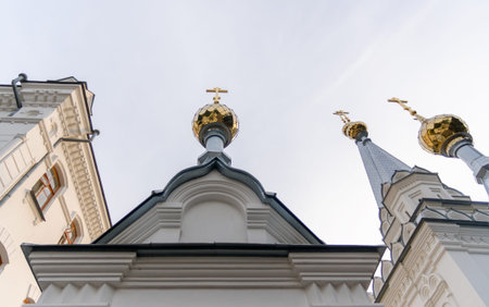 bottom view domes of christian church with crosses on blue sky background in Ukraine