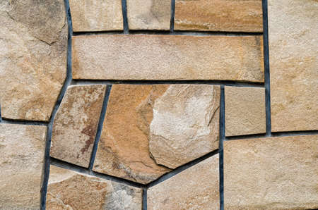 background old stone wall with abstract pattern close upの写真素材