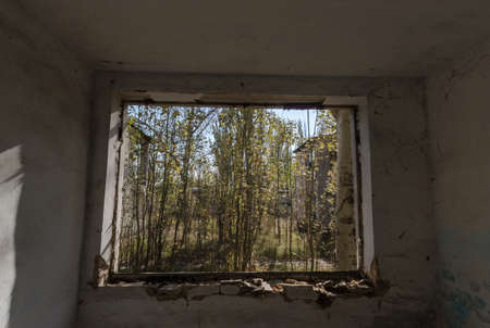 view from the window of an abandoned abandoned house in the village of Ukraine during the warの写真素材