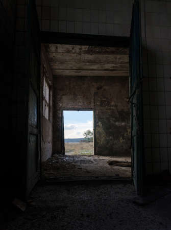 door exit from an abandoned bomb shelter after the bombing in Ukraine without peopleの写真素材