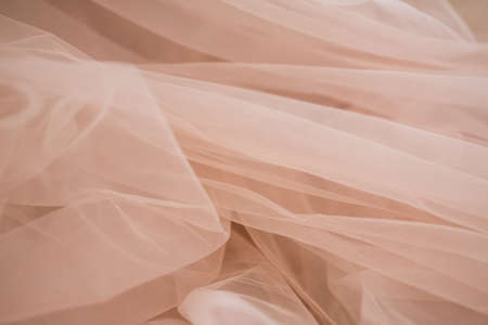 delicate soft beige fabric abstract background with blur close upの写真素材