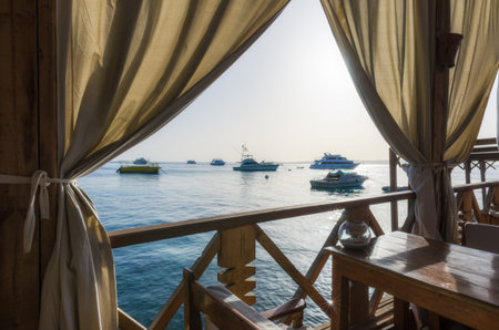 beach umbrellas and palm trees on the background of the red sea and ships in egypt hurghada