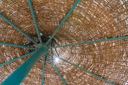 beach umbrella on blue sky background close upの写真素材