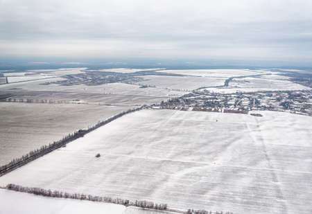 Ukraine winter landscape fields and roads view from the planeの写真素材