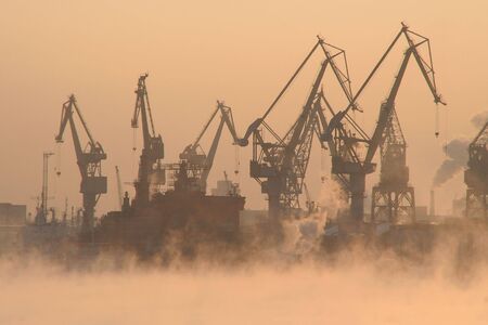some lifting cranes in a sea portの写真素材
