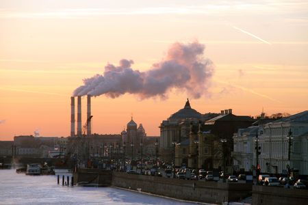 an evening city with chimney-stalks on sunsetの写真素材