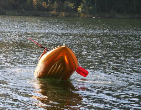 an inflatable rubber boat goes to a bottomの写真素材