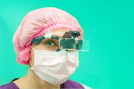 female surgeon doctor or intern wearing protective mask and hat.の写真素材