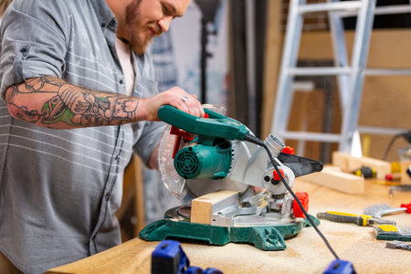 Man sawing wood with a circular saw on a workbench