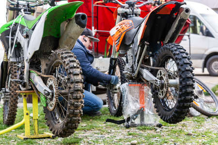 mechanic fixing motocycle wheelの写真素材