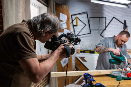 Behind the scenes of production for camera equipment video shooting, the set scene with the workerの写真素材