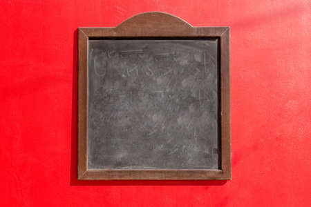 a black chalkboard and a red backgroundの写真素材