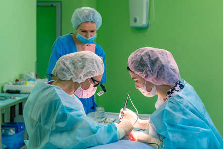 Surgeons team working with patient. breast augmentationの写真素材