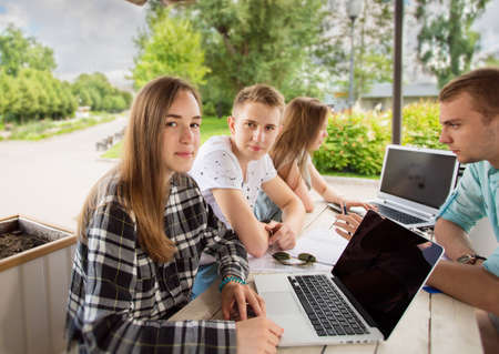 Group of young student using laptop outdoorの写真素材