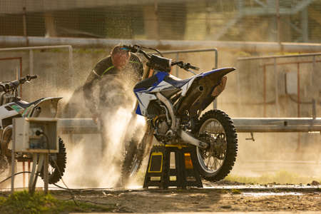 Bike rider washing his motorcycleの写真素材