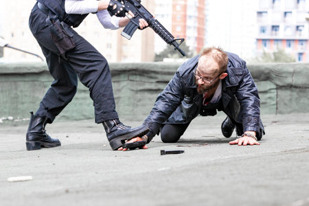 Woman soldier, spy agent killer or police woman with a gun in her hand holding at gunpoint a man...