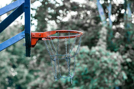 Picture of a basketball field goal with the trees in background.の写真素材