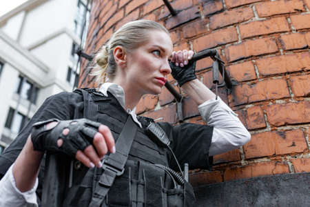 Powerful Woman Holding Gun. War Action Movie Styleの写真素材