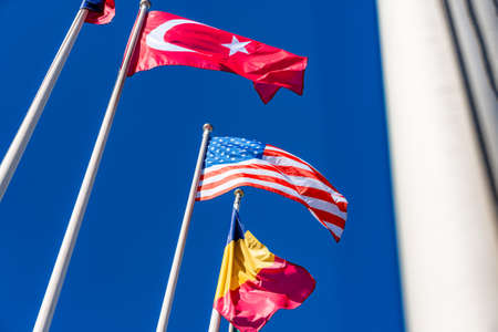 Flags of different countries flutters in the wind againstの写真素材