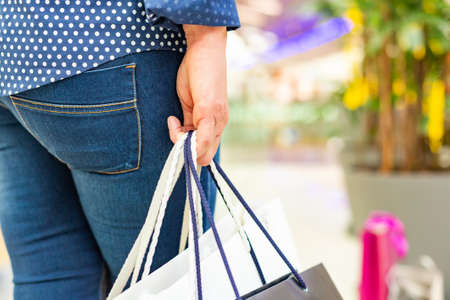 Fashion Shopping Girl Portrait. Beauty Woman with Shopping Bags in Shopping Mall. Shopper. Sales.の写真素材