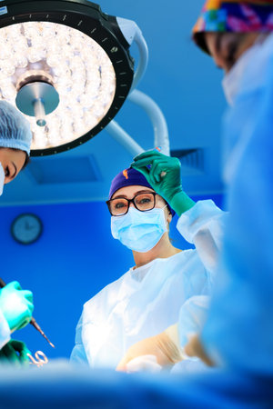 Surgeons operating a patient in operating room