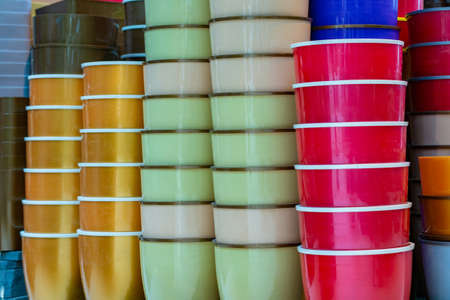 A lot of Colorful flowerpots on a market shelves.の写真素材