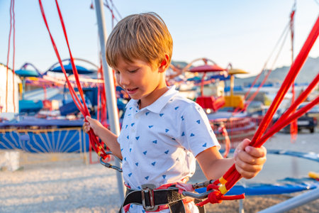 Smilling excited boy jumping on a trampoline with insurance.の写真素材