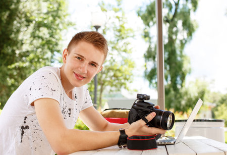 Attractive young man student using laptop outsideの写真素材