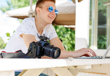 Attractive young man student using laptop outsideの写真素材