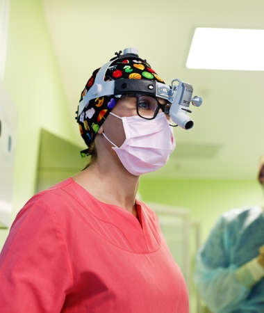 Surgeon operating a patient in operating roomの写真素材