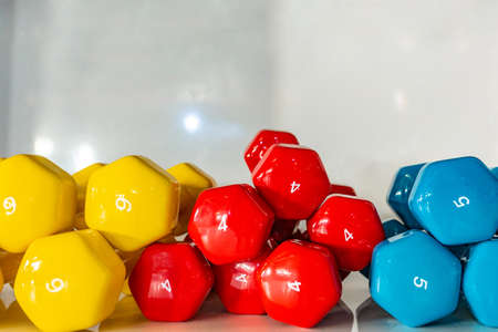 Dumbbells lying on the shelves. Gym. Equipment for a sports hall.の写真素材