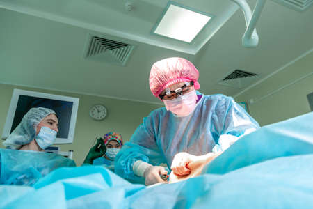 Surgeons team working in surgical operating roomの写真素材