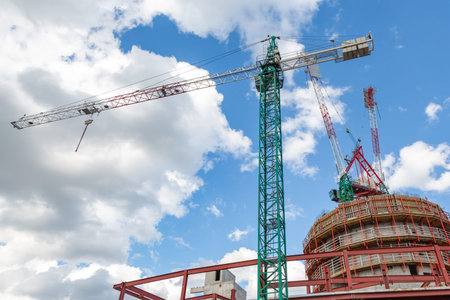Construction site with cranes, blue sky on the background